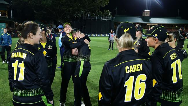 SYDNEY, AUSTRALIA - SEPTEMBER 30: Tayla Vlaeminck (L) and Ellyse Perry (R) of Australia celebrate victory with team mates after game two of the Women's Twenty20 International Series between Australia and Sri Lanka at North Sydney Oval on September 30, 2019 in Sydney, Australia. (Photo by Matt King/Getty Images)