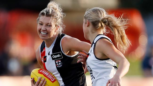 Rebecca Ott of the Saints is tackled by Brooke Vickers.