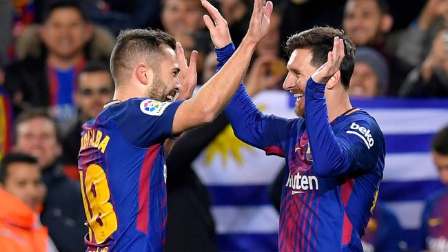 Barcelona's Argentinian forward Lionel Messi (R) celebrates with Barcelona's Spanish defender Jordi Alba.