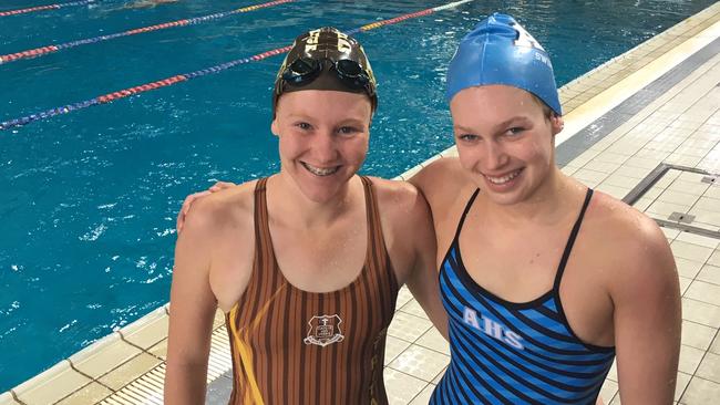 Lily Carrick (St Rita's), left, and Piper Brien (All Hallows) after Brien's win at the CaSSSA swimming carnival.