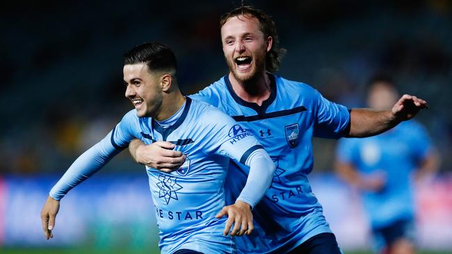 Sydney FC’s Marco Tilio, left, is embraced by Rhyan Grant after scoring the fastest debut goal in A-League history. Picture: AAP