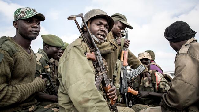 Soldiers of the Armed Forces of the Democratic Republic of the Congo prepare to escort health workers attached to ebola response programs. Picture: AFP