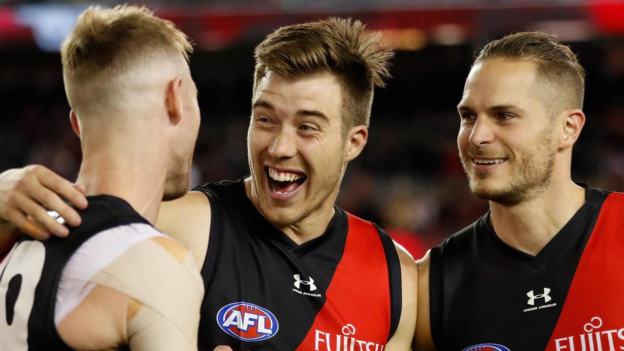 MELBOURNE, AUSTRALIA - MAY 23: (L-R) Nick Hind, Zach Merrett and David Zaharakis of the Bombers celebrate during the 2021 AFL Round 10 match between the Essendon Bombers and the North Melbourne Kangaroos at Marvel Stadium on May 23, 2021 in Melbourne, Australia. (Photo by Michael Willson/AFL Photos via Getty Images)