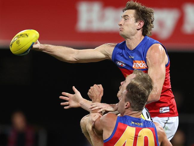 Harris Andrews of the Lions punches the ball out of defence. Picture: Michael Klein