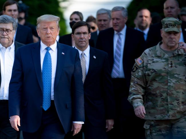 US President Donald Trump walks with then Chairman of the Joint Chiefs of Staff Mark Milley and others from the White House to visit St. John's Church after the area was cleared of people protesting the death of George Floyd in 2020. Picture: AFP