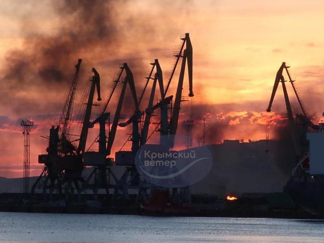 This photograph posted on the Telegram channel @VentdeCrimee on December 26, 2023 shows smoke rising above a damaged warship following a Ukrainian attack in the port of Feodosiya, Russian-controlled Crimea. Picture via AFP