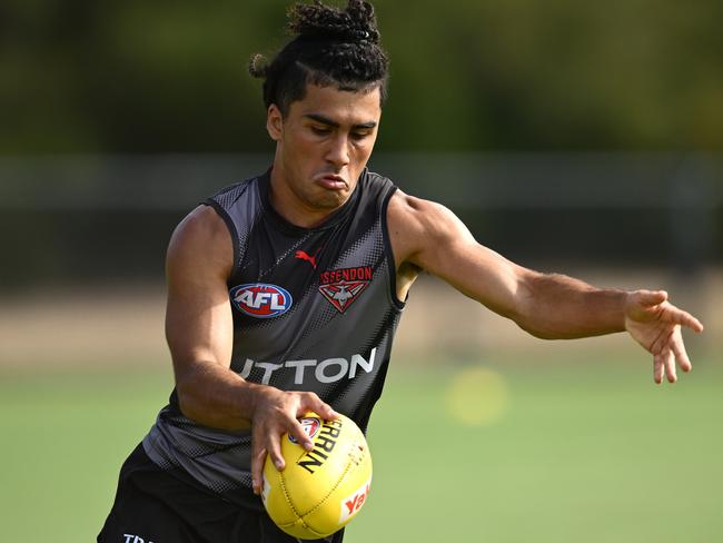 MELBOURNE, AUSTRALIA - MARCH 11: Isaac Kako of the Bombers kicks during an Essendon Bombers AFL training session at The Hangar on March 11, 2025 in Melbourne, Australia. (Photo by Quinn Rooney/Getty Images)