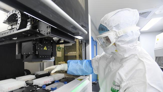 A laboratory technician working on samples from people to be tested for the new coronavirus in Wuhan in China's central Hubei province. Picture: AFP.