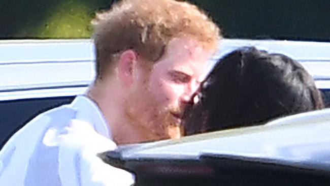 The couple steal a kiss at the Audi Polo Challenge at Coworth Park Polo Club, Ascot in May last year. Picture: Mega