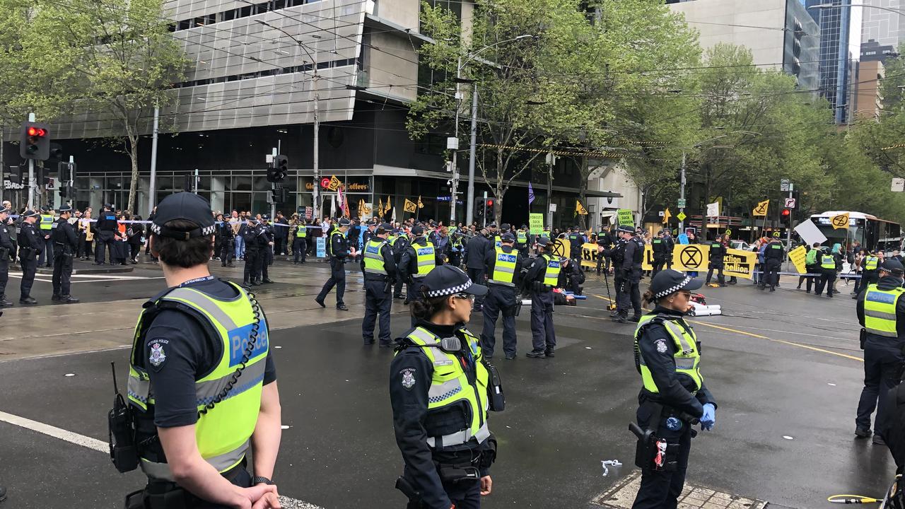 Police swarmed a busy Melbourne intersection after climate protesters forced it into lockdown. Picture: Aneeka Simonis