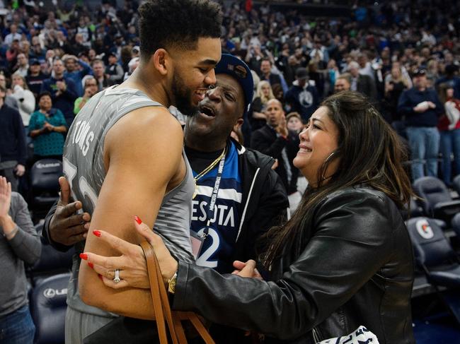 MINNEAPOLIS, MN - APRIL 11: Karl-Anthony Towns #32 of the Minnesota Timberwolves hugs his parents, Karl and Jackie Towns after winning the game against the Denver Nuggets of the game on April 11, 2018 at the Target Center in Minneapolis, Minnesota. The Timberwolves defeated the Nuggets 112-106. NOTE TO USER: User expressly acknowledges and agrees that, by downloading and or using this Photograph, user is consenting to the terms and conditions of the Getty Images License Agreement. (Photo by Hannah Foslien/Getty Images)