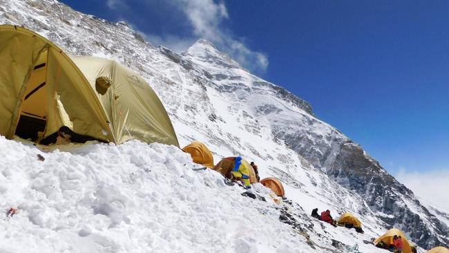 Camp 3 tents pitched in steep terrain on the side of the mountain.