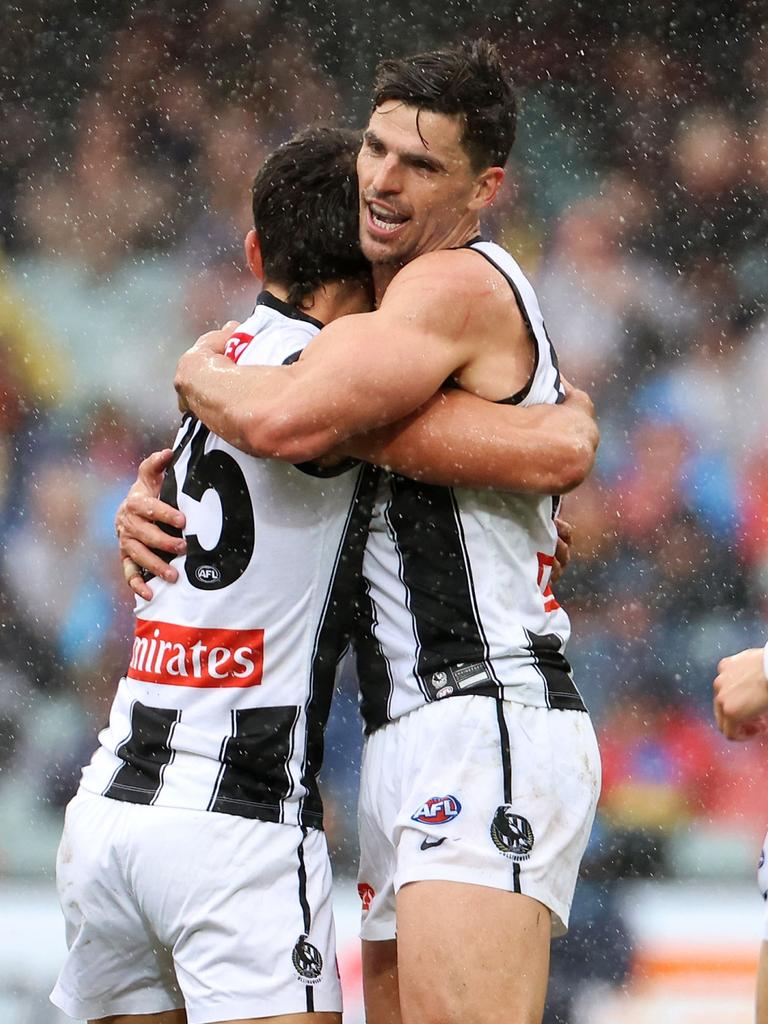 Daicos is congratulated by Scott Pendlebury after one of his three goals.