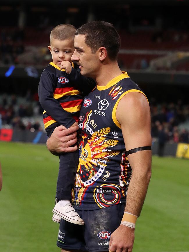 Walker with Hugo after the Crows loss to the Demons at the Adelaide Oval on July 2, 2022 Photo by Sarah Reed/AFL Photos via Getty Images.