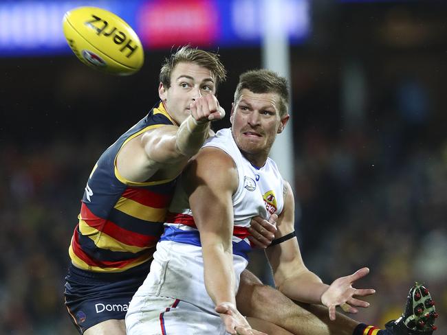 Daniel Talia punches the ball away from Jack Redpath. Picture Sarah Reed