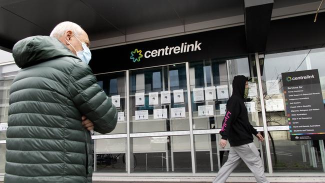 A man waits outside Centrelink in South Melbourne. Picture: David Geraghty