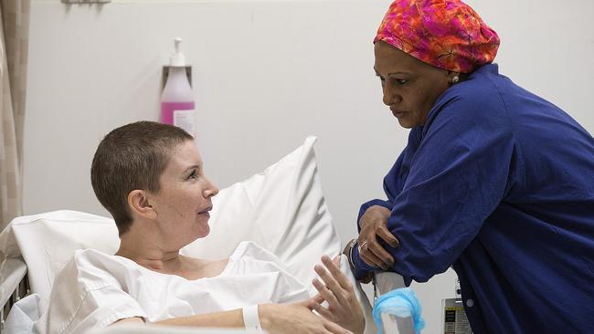 Flora Purvis chats with hospital orderly Tesgeweini Berhane ahead of her surgery at St Vincent's Hospital. Picture: Ian Currie