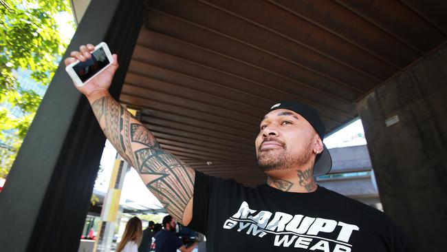 Christopher Howard Bloomfield takes a cheeky selfie as he leaves the Brisbane Magistrates Court.