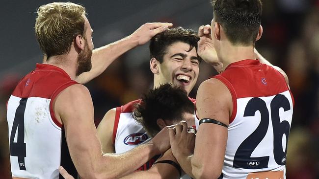 Melbourne players celebrate a goal on their way to beating top team Adelaide last weekend. The Demons are 10th on the ladder. Picture: AAP