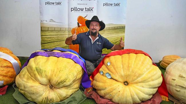 GIANT PUMPKIN: Minden grower Tony Frohloff with his first and second place winning pumpkins that took out the RNA Giant Pumpkin Competition. Picture: Rommel Carlos