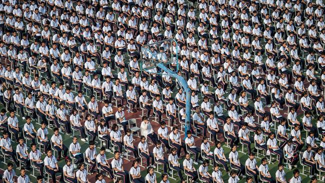 Students attend the 100th anniversary of the founding of Wuhan High School on the first day of the new semester in Wuhan in China's central Hubei province on Tuesday. Picture: AFP