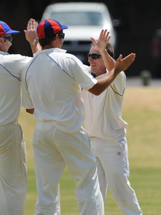 Gav Symes (right) celebrates a wicket.