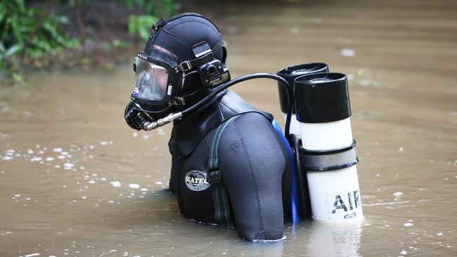 A police diver searches a dam for William Tyrrell's remains near Kendall. Picture: Peter Lorimer.