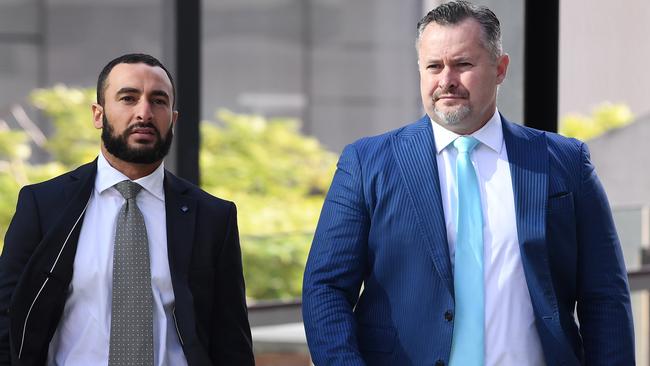 Adam Magill (right) and his lawyer Ahmed Dib arrive at the Brisbane Magistrates Court in Brisbane last year for a mention relating to four charges of breaching his bail. Picture: Dave Hunt