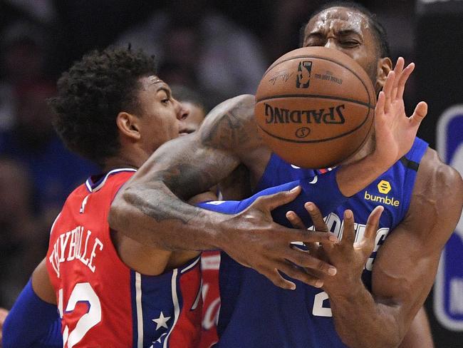 Philadelphia 76ers guard Matisse Thybulle, left, knocks the ball from the hands of Los Angeles Clippers forward Kawhi Leonard during the second half of an NBA basketball game Sunday, March 1, 2020, in Los Angeles. The Clippers won 136-130. (AP Photo/Mark J. Terrill)