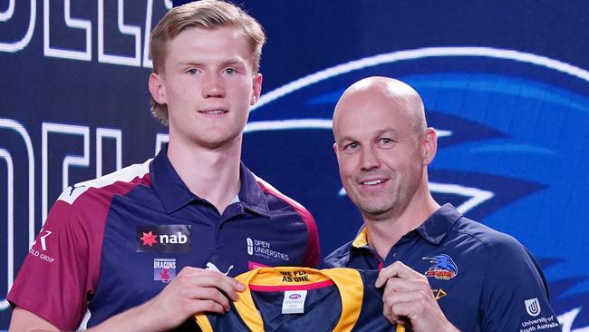 Sixth AFL Draft pick Fischer McAsey is presented with a jersey by Adelaide Crows coach Mathew Nicks after being drafted. The utility is set to get a chance to cement a Round 1 spot (AAP Image/Michael Dodge)