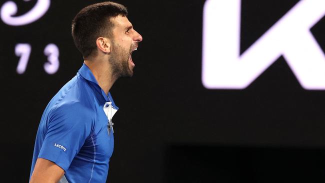 Serbia's Novak Djokovic celebrates a match point against Australia's Alexei Popyrin during their men's singles match on day four of the Australian Open tennis tournament in Melbourne on January 17, 2024. (Photo by David GRAY / AFP) / -- IMAGE RESTRICTED TO EDITORIAL USE - STRICTLY NO COMMERCIAL USE --