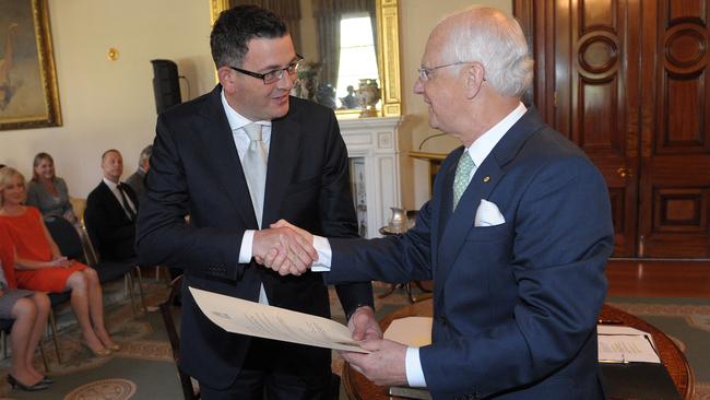 Daniel Andrews (left) shakes hands with Governor Alex Chernov as he is sworn in as Victoria's Premier in 2014. Picture: AAP Image/Julian Smith