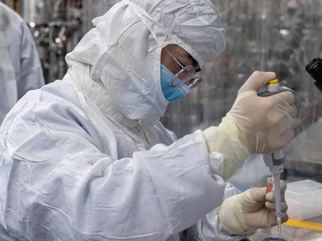 (FILES) This file photo taken on April 29, 2020 shows an engineer taking samples of monkey kidney cells as he make tests on an experimental vaccine for the COVID-19 coronavirus inside the Cells Culture Room laboratory at the Sinovac Biotech facilities in Beijing. - Sinovac Biotech is conducting one of the five clinical trials of potential vaccines that have been authorised in China. China would make any coronavirus vaccine it developed a "global public good" once it was put into use, President Xi Jinping told the World Health Assembly on May 18, 2020. (Photo by NICOLAS ASFOURI / AFP)