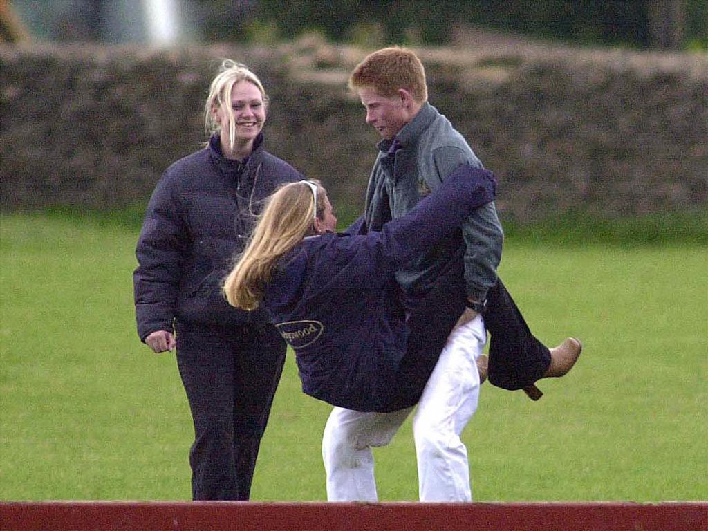 Prince Harry has a laugh with a friend as Sasha Walpole, on left, looks on. Picture: Getty Images