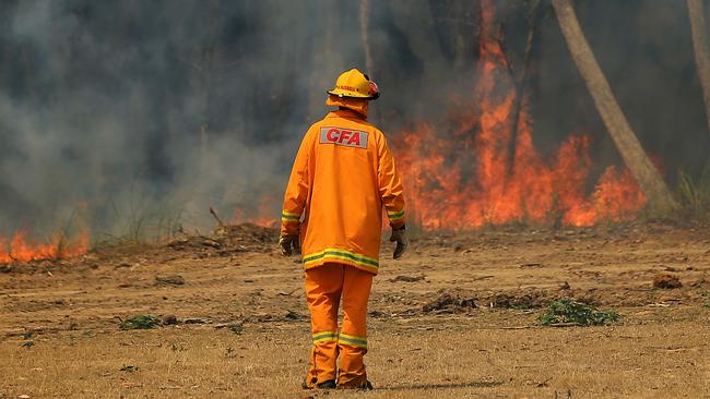 A firefighter works to protect assets impacted by the Bunyip blaze outside Gembrook. Picture: Mark Stewart