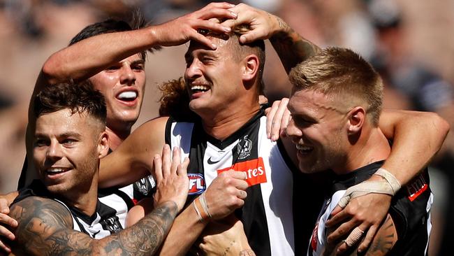 Nathan Kreuger is mobbed by De Goey and Co. after he kicked a goal against the Crows. Picture: AFL Photos/Getty Images