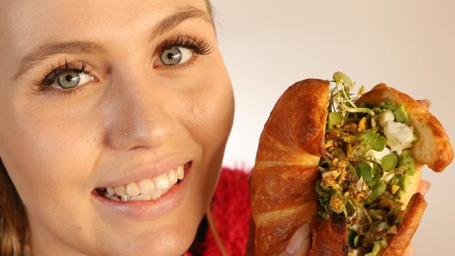 Local &amp; Co launched in 2016 with its ‘hero’ product the crushed avo croissant. Pictured is staff member Emma Stewart with the croissant. Picture Glenn Hampson