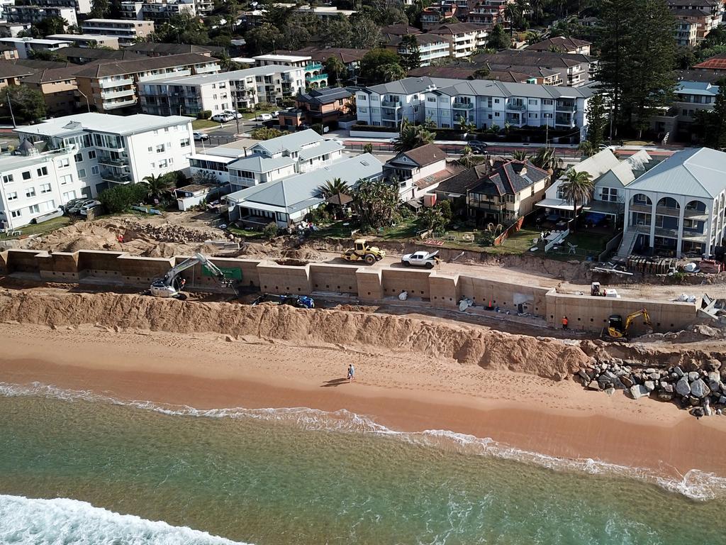 Construction work on the new sea wall being built to protect homes at Sydney’s Collaroy Beach. As sea levels rise, more coastal areas will be forced to take measures against beach erosion. Picture: Jonathan Ng