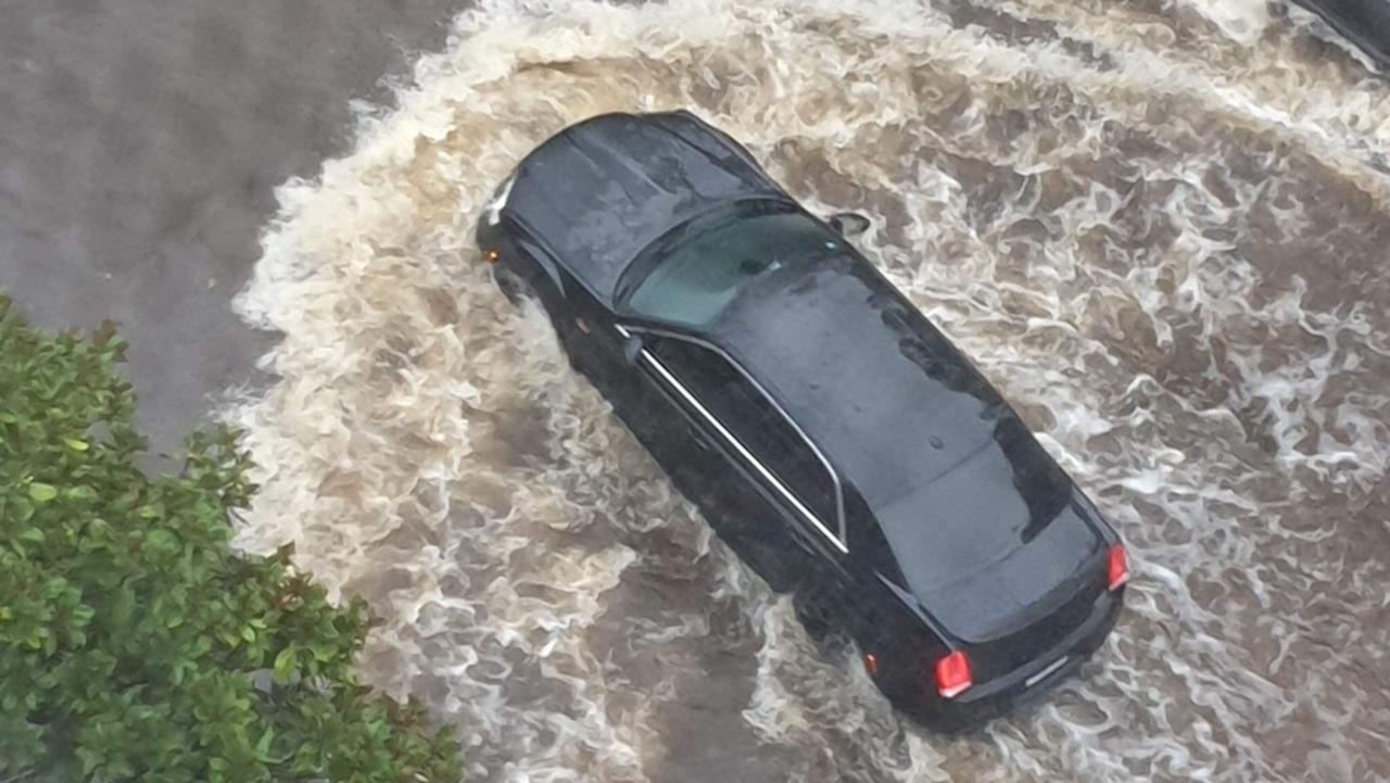 A car is seen in floodwaters in Wentworth Point. Picture: Lee Williams