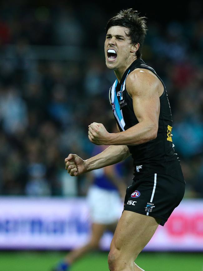 Pembroke old scholar Angus Monfries celebrates a goal for Port Adelaide in 2015. Picture: Sarah Reed