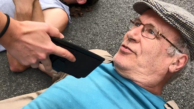 A climate protester lays on the street.