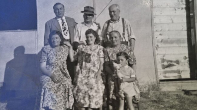 Grace Natoli's grandfather, Giovanni, and his two brothers, Domenico and Bartolo, who was the grandfather of Robert and Maria Natoli. A young Robert can be seen sitting on his grandmother's lap, with his pregnant mother in the middle. Photo: Supplied with permission.