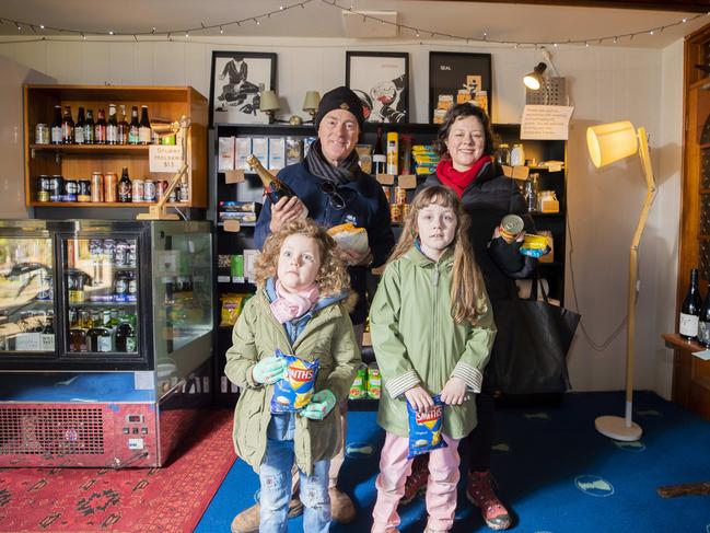 Fern Tree locals Christopher Lawrence and Julia Fredersdorff with their children Mina, 8 and Belle, 5, pick up some goods at the new grocer at the Fern Tree Tavern. Picture: RICHARD JUPE