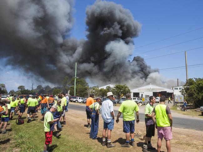 Staff watch the fire at Big River Timbers after being evacuated from the site. Picture: Adam Hourigan.