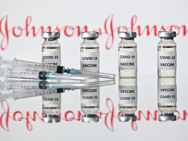 (FILES) A file photo taken on November 17, 2020 shows vials with Covid-19 Vaccine stickers attached and syringes with the logo of US pharmaceutical company Johnson & Johnson. - The Johnson & Johnson vaccine is highly effective against severe Covid-19, including against the South African and Brazil variants, new documents released by the US Food and Drug Administration showed on February 24, 2021. In large clinical trials, the vaccine efficacy against severe disease was 85.9 percent in the United States, 81.7 percent in South Africa, and 87.6 percent in Brazil. (Photo by JUSTIN TALLIS / AFP)