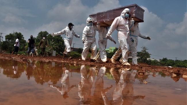 Gravediggers carry the coffin of a victim who died from Covid-19 in Bekasi near Jakarta in Indonesia. Picture: AFP