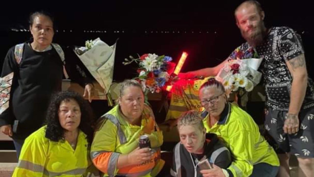 Workmates of Brendan Moreland pay tribute to the popular traffic controller at the site where he died. Back: Mirikia Ahmat and Matthew Wellington. Front: Sharon Ahmat, Deliah Serruerier, Nezzy Falzon and Robyn 'Robbi' Mapley.