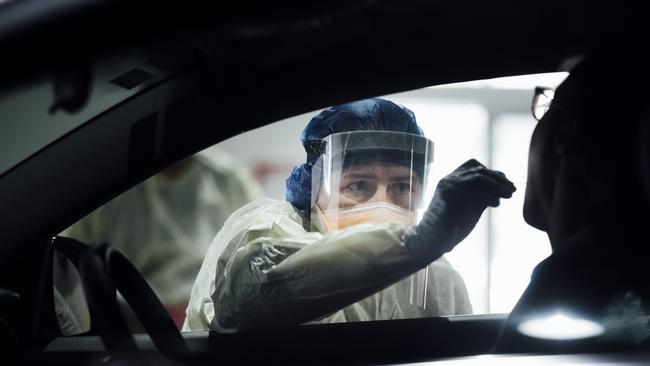 Nurses test a patient at the ACT's drive through COVID-19 testing site. Picture: Getty Images