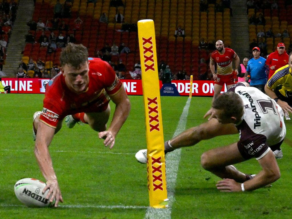 Tom Trbojevic goes flying over the sideline as Jack Bostock scores in the corner for the Dolphins. (Photo by Bradley Kanaris/Getty Images)