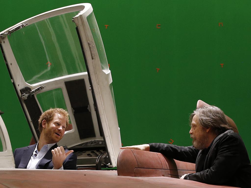 Britain’s Prince Harry sits in an A-wing fighter as he talks with US actor Mark Hamill during a tour of the Star Wars sets at Pinewood studios in Iver Heath, west London, Tuesday April 19, 2016. Picture: AP